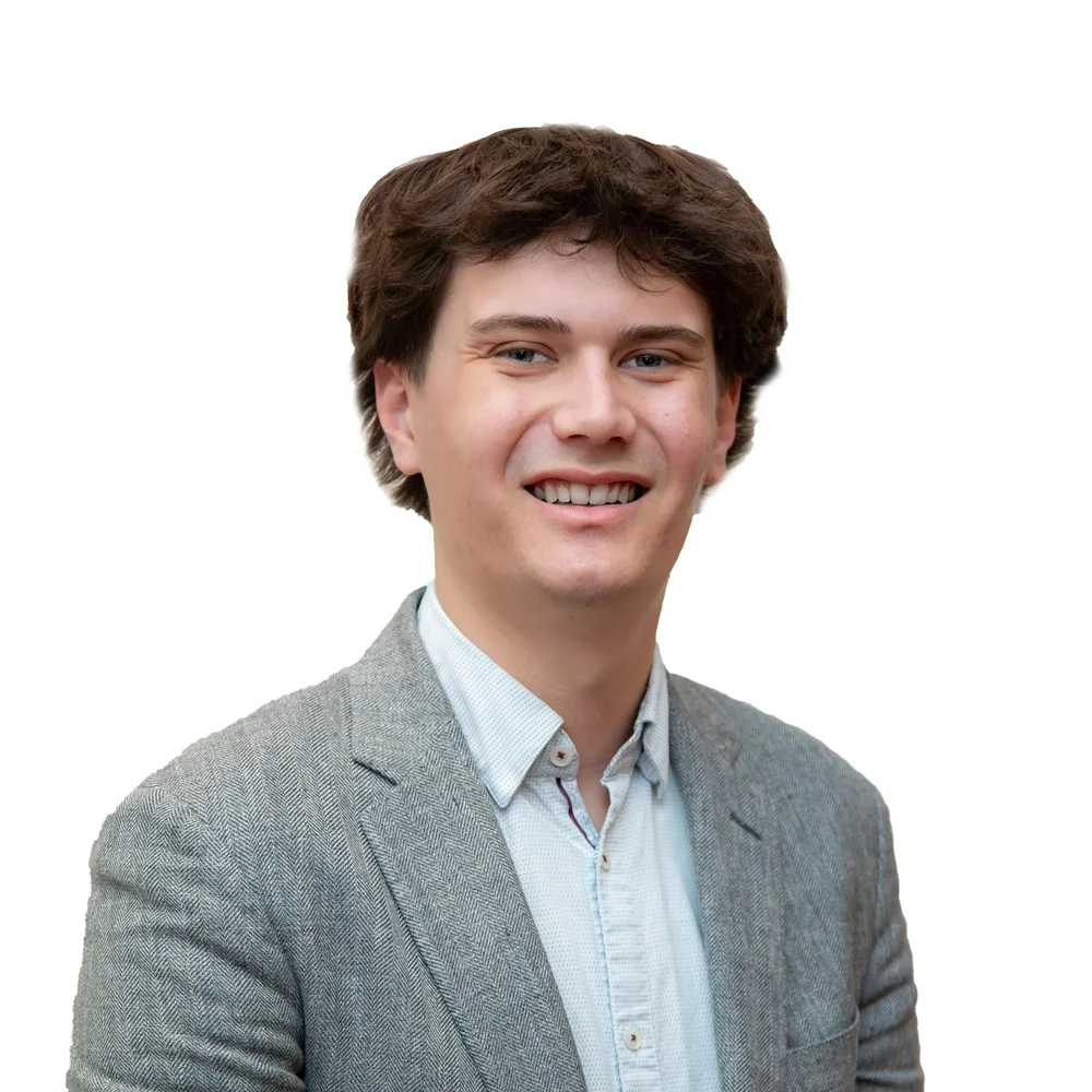 Portrait of Bretton Fischer in a gray blazer.